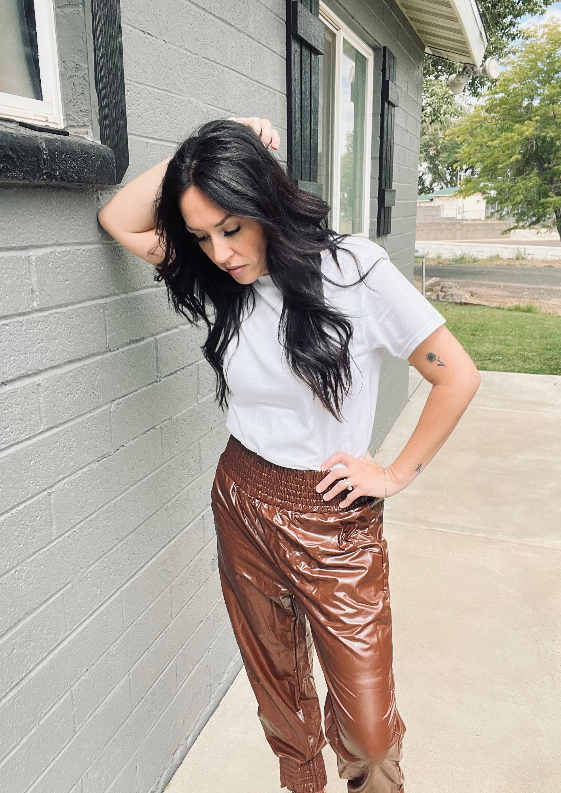 Brown faux leather jogger pants with relaxed elevated streetwear styling