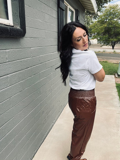 Brown faux leather jogger pants with relaxed elevated streetwear styling
