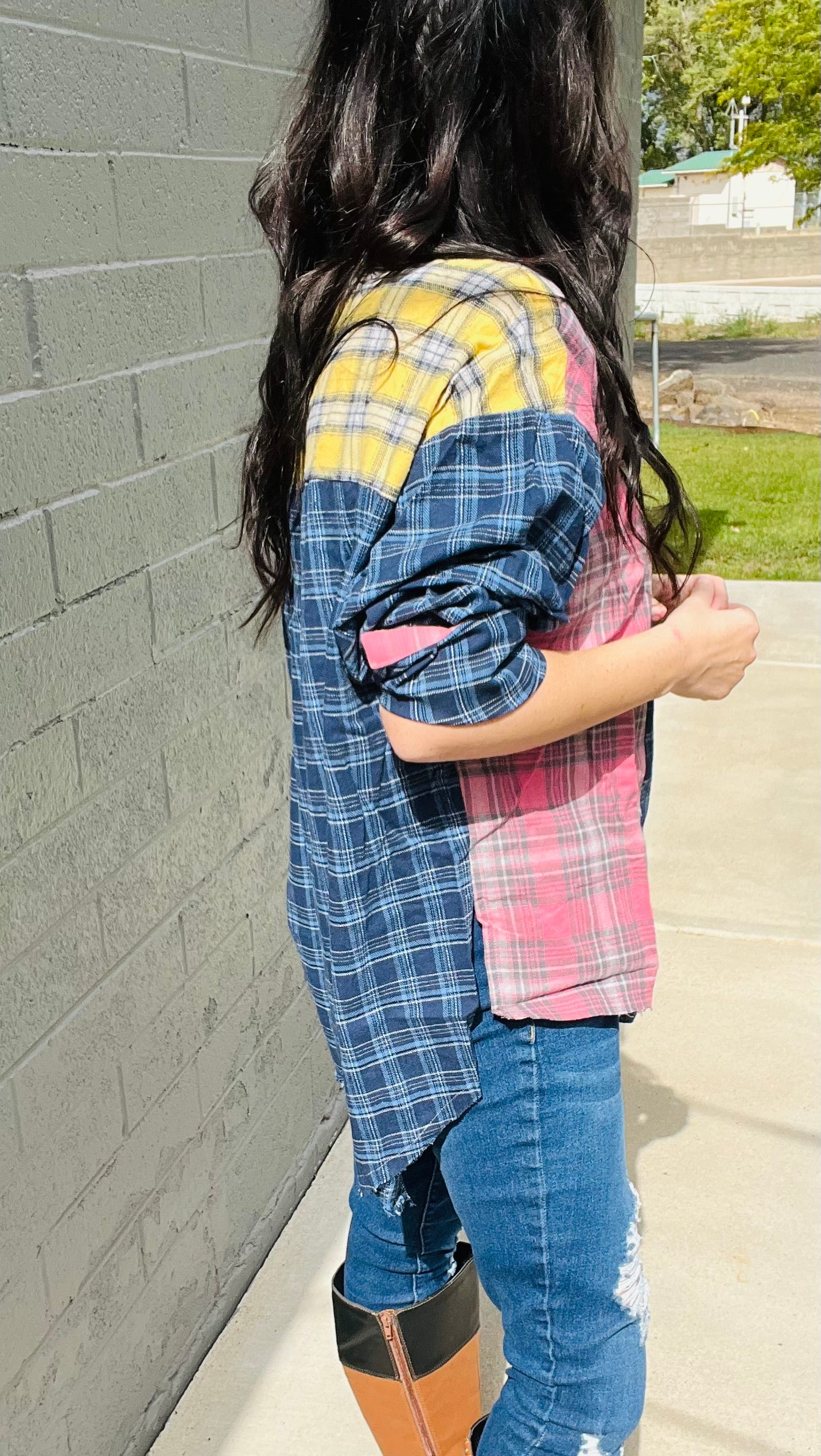 Oversized patchwork plaid flannel shirt styled with distressed denim jeans