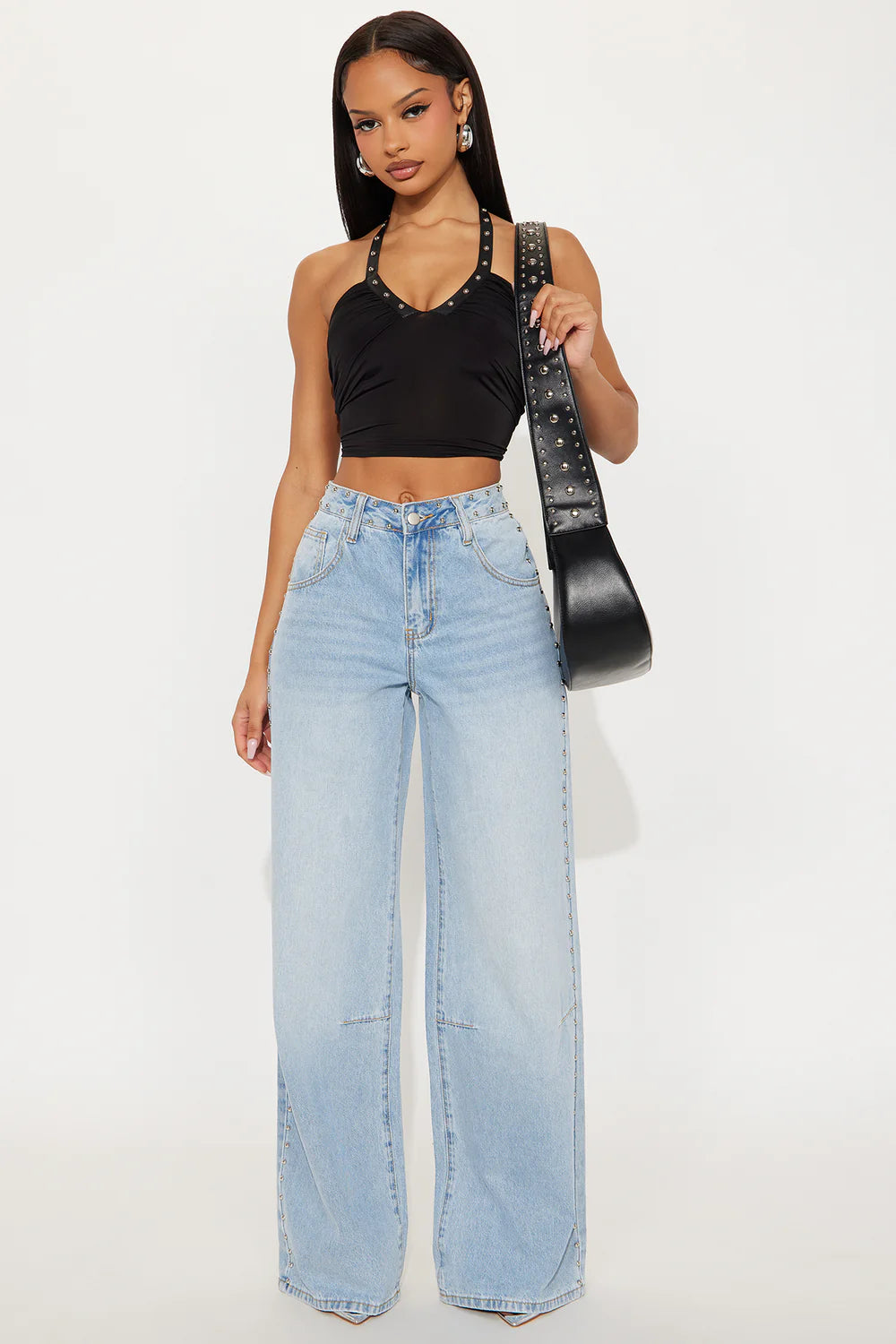 Light wash wide leg jeans with silver stud details and edgy streetwear styling