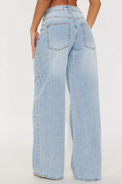 Light wash wide leg jeans with silver stud details and edgy streetwear styling