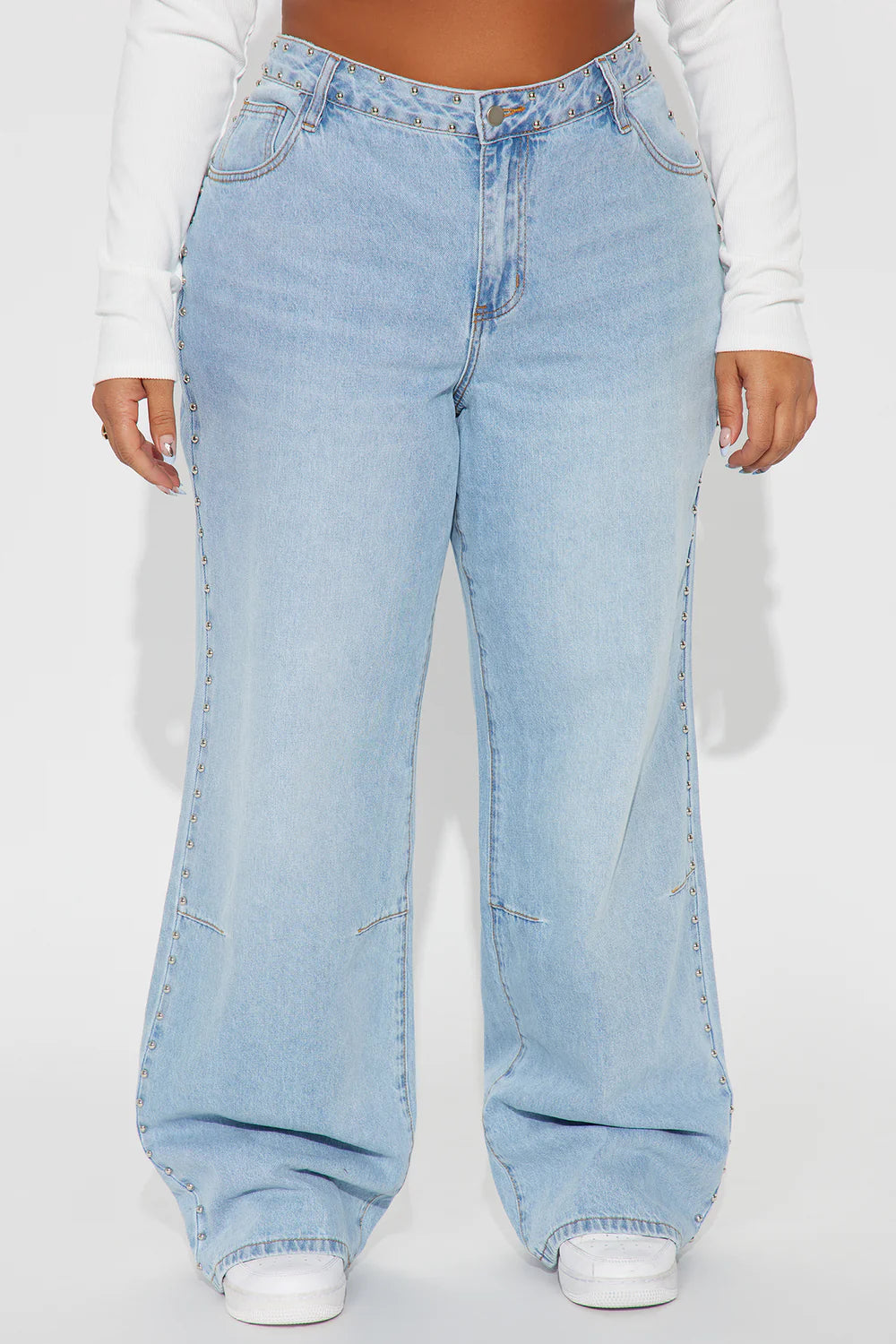 Light wash wide leg jeans with silver stud details and edgy streetwear styling