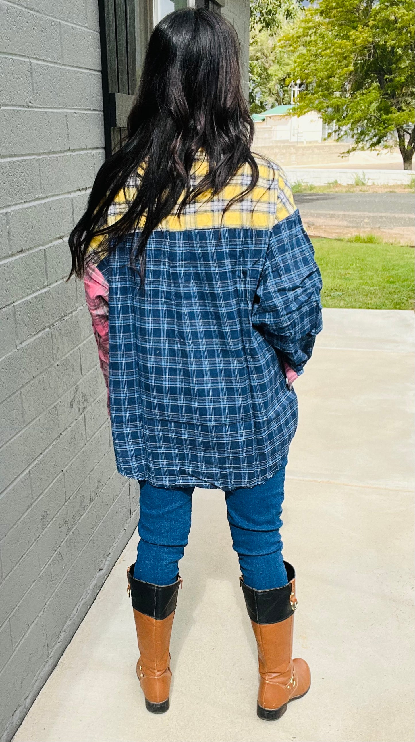 Oversized patchwork plaid flannel shirt styled with distressed denim jeans