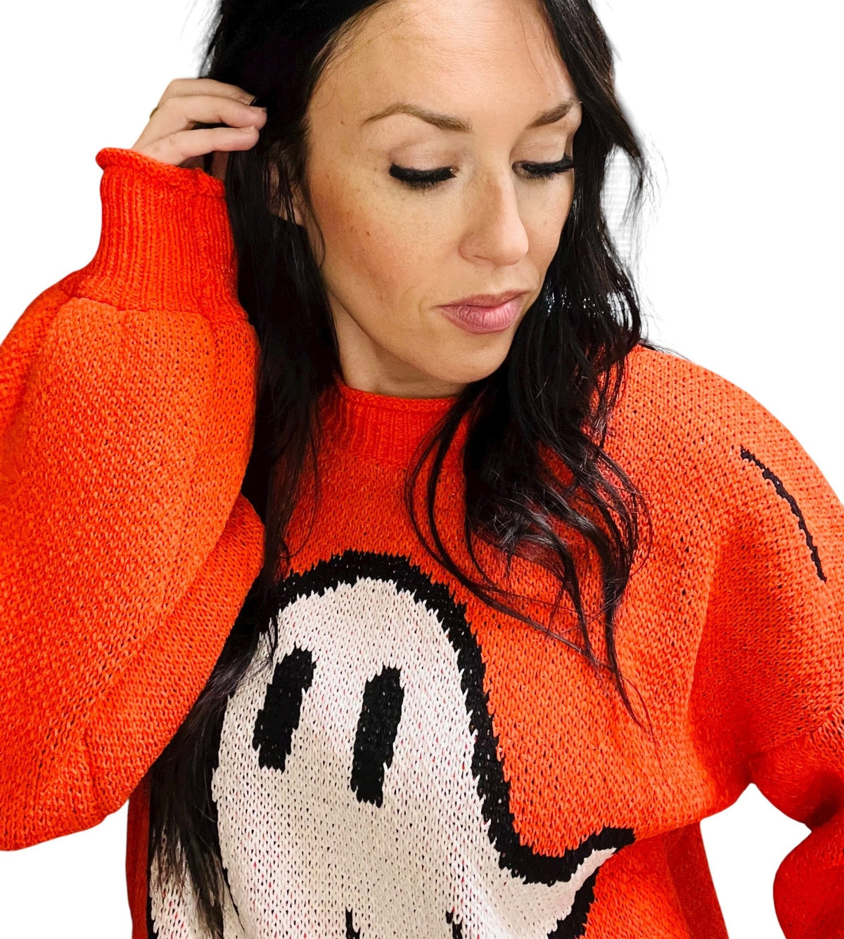 Person wearing a red sweater with a cartoon character design on a white background