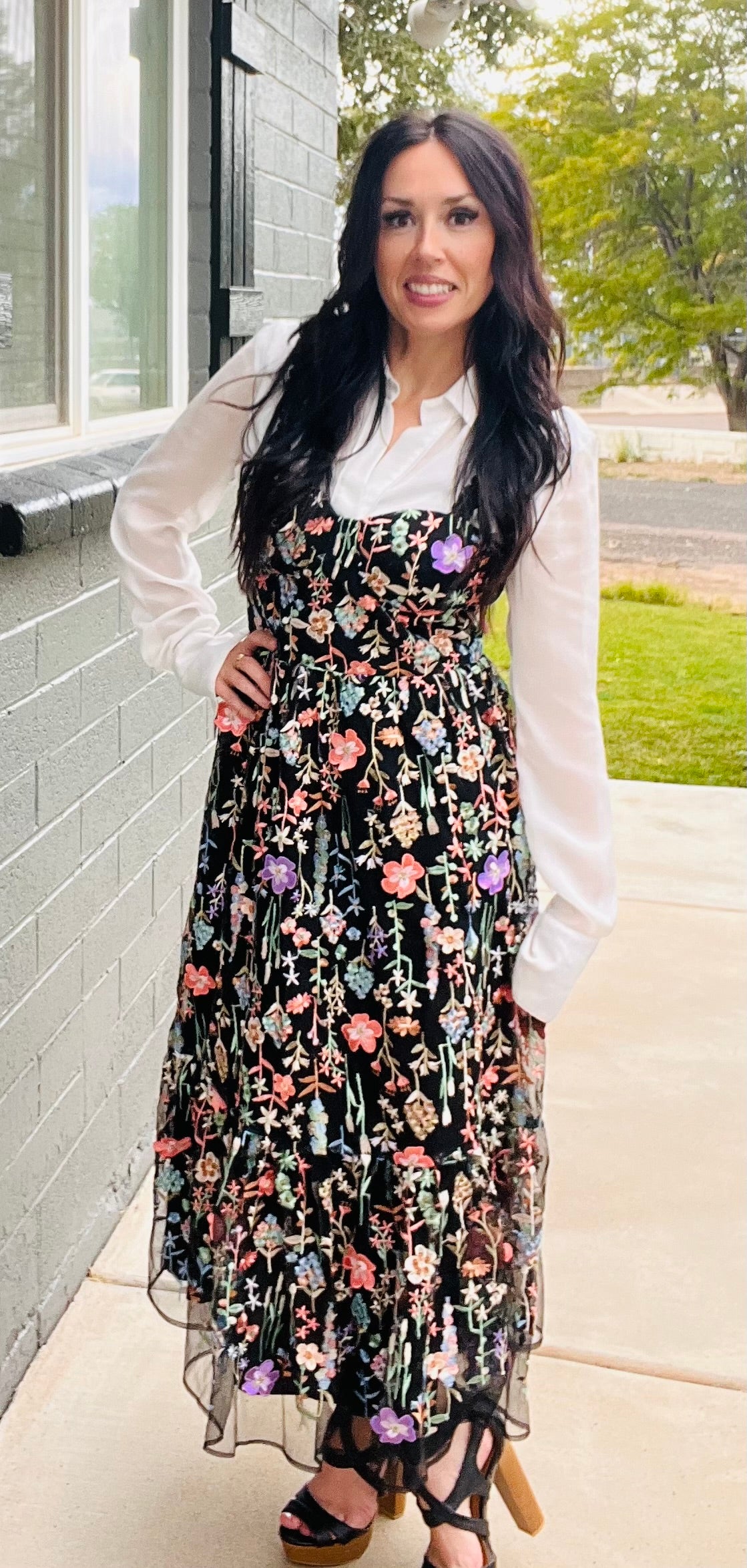 Black embroidered floral mesh midi dress layered over long sleeve white top