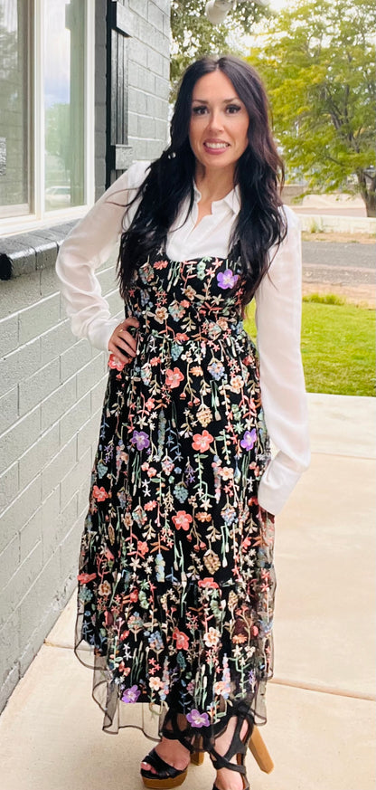 Black embroidered floral mesh midi dress layered over long sleeve white top